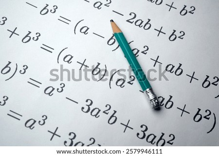 Mathematical equations and algebraic formulas written on paper with a green pencil. Educational concept for mathematics, algebra, geometry, problem solving, learning, school, university, homework and scientific research.