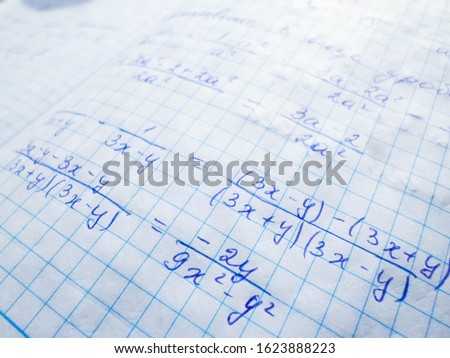 mathematical formulas are written in a notebook. solution school examples in algebra and geometry
