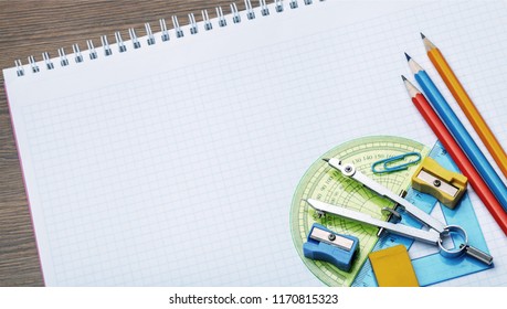 Mathematical Instruments Over The Corner Of A Math Graph Paper With Copy Space For Text. Math Graphic Tools Concept.