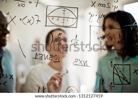 Mathematicians working to solve equation.
