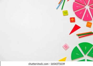 Mathematics background - fractions on white table, close up. Dividing fractions, math concept, copy space