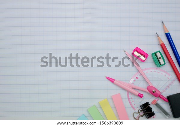 Mathematics concept, Writing utensils. A thumbscrew\
compass for setting and maintaining a precise radius, Ruler,\
eraser, placed on a graph\
book.