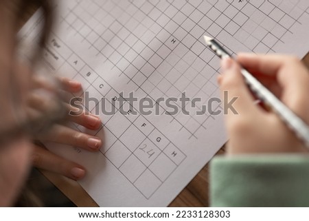 Mathematics homework.Homework.Math lesson.student is doing a math assignment.Study and education concept.schoolgirl does her homework. Close-up pencil in a childs hand writes in a notebook