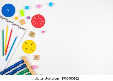 Mathematics Learning Resources On White Background. Early Math Skills. Colorful Abacus, Math Fractions, Geometric Solids On White Desk. Top View, Flat Lay