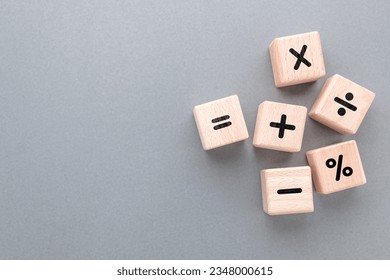 Mathematics operation signs by wood cubes, learning mathematics, and calculation concept
