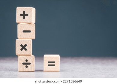 Mathematics operation signs on wood cubes, plus, minus, multiply, divide, and equal sign for calculating or education concept