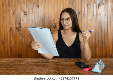 Mathematics teacher observing the themes for the next class. Teacher reviewing the notes given to his students - Powered by Shutterstock