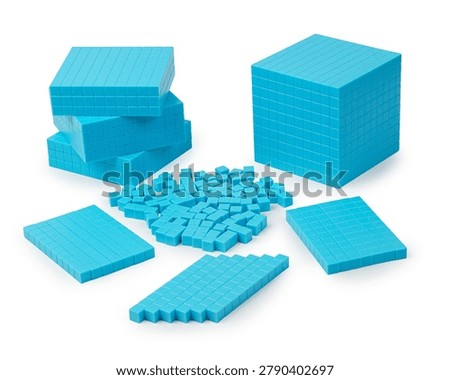Mathematics teaching materials with unit cubes, flat squares and a thousand block cube arranged on a white background. Ideal visual for educational, counting and numeracy themes.                           