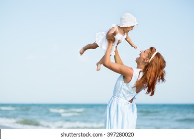 Mather And Baby On The Sea Beach