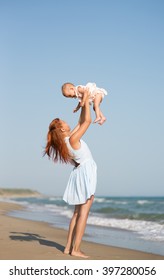 Mather And Baby On The Sea Beach