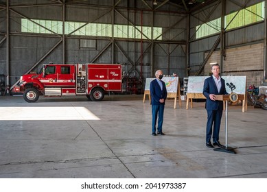 MATHER, CA, US.A. - SEPT. 13, 2021: Gov. Gavin Newsom Speaks While President Joe Biden Watches.  A Cal Fire Firetruck And Maps Are Behind Them In A Hangar, And Biden's Visit Included An Aerial Tour.