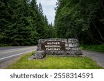 Mather Memorial Parkway sign made in classic US Park Service stone and wood style, exploring Mt. Rainier National Park in the summer
