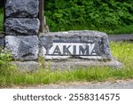 Mather Memorial Parkway sign pointing to Yakima, made in classic US Park Service stone and iron style, exploring Mt. Rainier National Park in the summer
