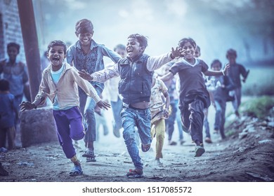 MATHURA, INDIA - Feburary 23,2018: Group of boisterous Indian children running for photograph in Agra, Uttar Pradesh, India.