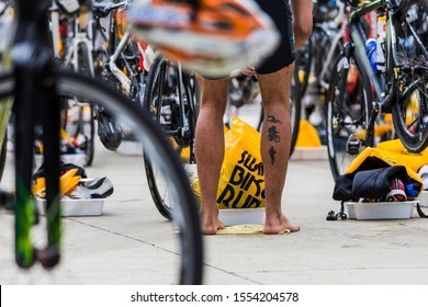 Matinhos/ Parana/ Brazil - october/ 26/ 2019- Transition area in a triathlon competition, tattooed leg of an athlete in the background.