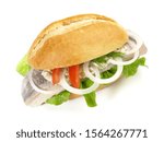 Matjes Fish Bun with Onions and Remoulade Sauce isolated on white Background. Raw herring soaked in a mild preserving liquid. Dutch brined. 