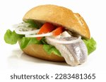 Matjes Fish Bun with Onions and Remoulade Sauce isolated on white Background. Raw herring soaked in a mild preserving liquid. Dutch brined.