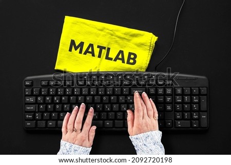 Matlab programming language. Rag width word matlab and hands on pc keyboard.
