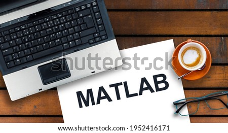 MATLAB programming language. Word Matlab on paper and laptop