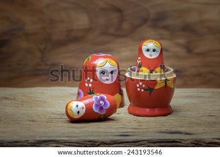 Matryoshka, a Russian wooden doll on wooden table