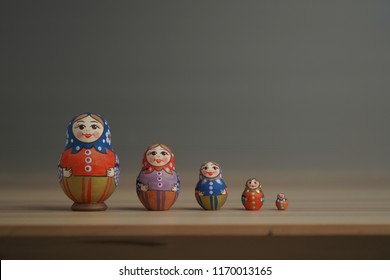                           Matryoshka traditional Russian dolls are on the wood table.     
