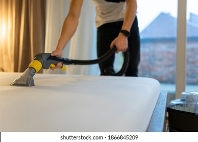 Mattress Cleaning Process. Man Cleans Bed From Dirt And Bacteria