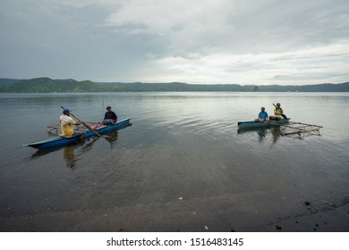 Matupit, East New Britain / Papua New Guinea - July 4, 2019: A Group Of Tolai People Get Ready To Travel By Traditional Wooden Boat To Rabaul City Market In Calm Sea Waters