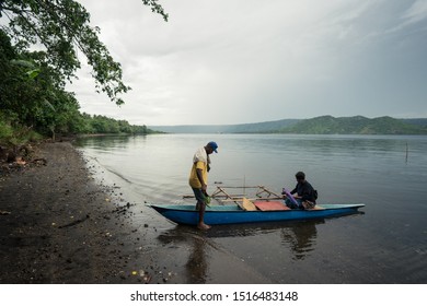 Matupit, East New Britain / Papua New Guinea - July 4, 2019: A Group Of Tolai People Get Ready To Travel By Traditional Wooden Boat To Rabaul City Market In Calm Sea Waters