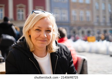 Mature 50s Caucasian Woman With Blond Hair Outdoors On Sunny Day. European Travel 