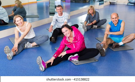 Mature Active Adults Doing Pilates Routine In A Sport Club