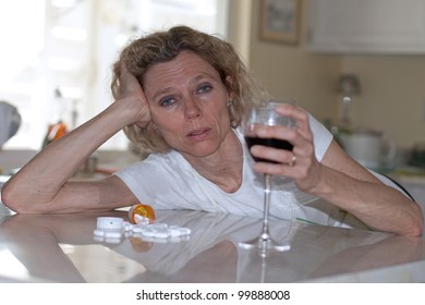 Mature Addicted Woman Drinking Wine And Pills