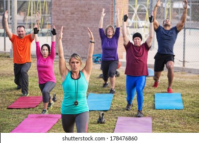 Mature Adult Boot Camp Fitness Class Stretching Outdoors