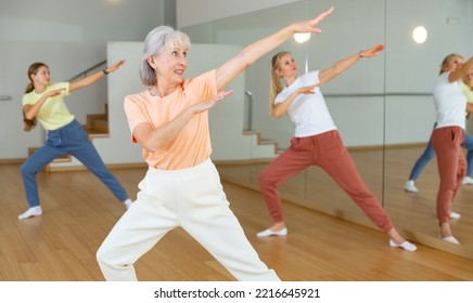 Mature Adult Female Dancing With Other Women During Group Class In Dance Center