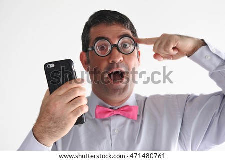 Mature adult geeky businessman wearing reading glasses holding a smartphone has an idea looking at the camera. Communication concept. isolated on white background. Real people. Copy space