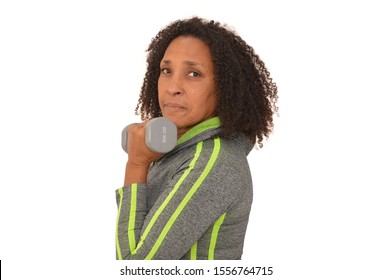 Mature Adult Post Menopause Woman Lifting Weight Strength Training Looking At Camera White Background