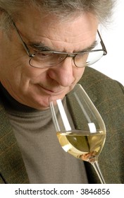 Mature Adult Sniffing A Glass Of White Wine