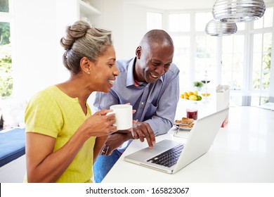 Mature African American Couple Using Laptop At Breakfast - Powered by Shutterstock