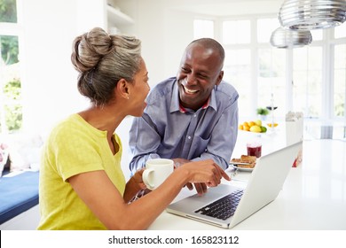 Mature African American Couple Using Laptop At Breakfast - Powered by Shutterstock