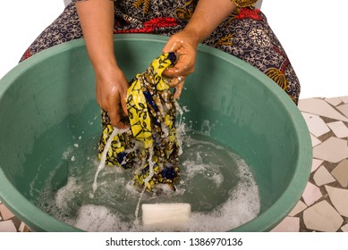 Mature African Woman In Loincloth Sitting Doing Laundry.