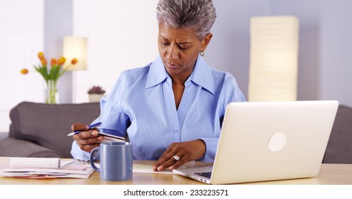 Mature African Woman Paying Her Bills