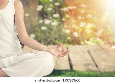 Mature African Woman Practicing Yoga And Meditates Near Swimming Pool Outdoor. Fitness Black Lady Sitting In Lotus Pose With Closed Eyes. African American Woman Meditating At Poolside With Copy Space.