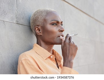 Mature African Woman Smoking A Cigarette In The City Outdoors