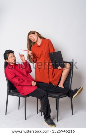 Mature Asian businesswoman and weird Asian woman therapist having consultation together
