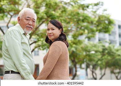 Mature Asian Couple Walking Outdoors Together