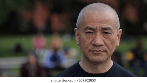 Mature Asian Man In City Park Face Portrait Serious