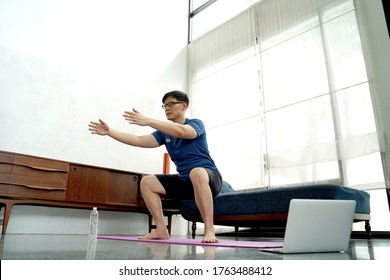 Mature Asian Man Doing Exercises At Home. Workout At Home. Social Distancing.