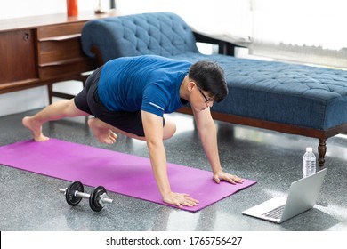 Mature Asian Man Doing Exercises At Home. Workout At Home. Social Distancing.