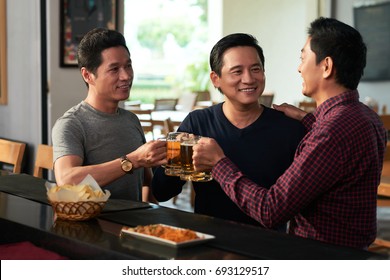 Mature Asian Man Toasting For His Friends