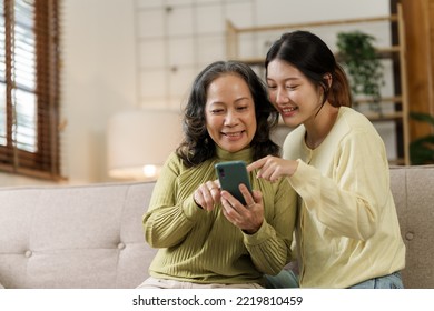 Mature asian mom with daughter on video call to parents, loving mother day concept. - Shutterstock ID 2219810459
