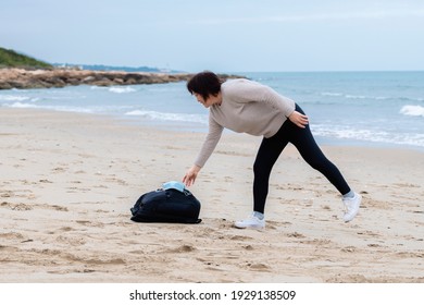 Mature Asian Woman Reaching For Her Mask